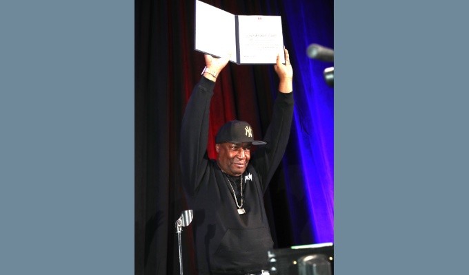 AES New York 2019 Convention keynote speaker Grandmaster Flash shows off his AES Honorary Member award, given for pioneering revolutionary and influential implementations of audio and music technologies for performance.